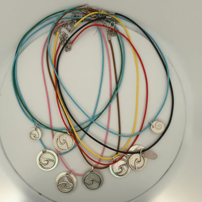 A set of colorful cord necklaces with silver spiral pendants, arranged on a white background.