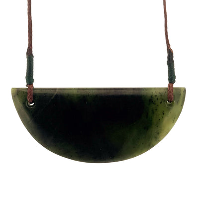 Green stone pendant on a white background