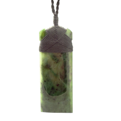 Green stone pendant with woven top on a white background
